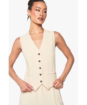 Sleeveless waistcoat with linen-look texture for a relaxed yet refined aesthetic
        V-neckline and button-through front with contrasting buttons for added visual interest
        Tailored fit designed specifically for taller frames, offering proper proportions
        Practical front pockets perfect for small essentials or a casual hand placement
        Versatile layering piece that transitions effortlessly between seasons
    
    This linen-look waistcoat brings a touch of understated sophistication to your wardrobe. Designed with the taller frame in mind, it offers the perfect proportions for a flattering silhouette. Style it as seen with relaxed denim jeans for an effortlessly cool daytime look, or pair with tailored trousers and a crisp shirt for more formal occasions. The neutral tone makes it incredibly versatile - layer under a blazer during cooler months or wear alone with statement jewellery when temperatures rise. Perfect for family gatherings, casual office environments, or weekend brunches, this Boohoo waistcoat can be customised to suit your personal style. The textured fabric adds dimension to any outfit whilst maintaining a comfortable, breathable feel that's ideal for all-day wear.