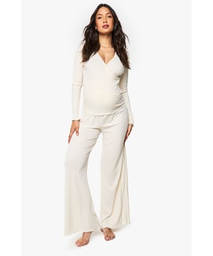 Ribbed wrap-style top with elegant ruched hem detail for added texture
        Flattering V-neckline that provides comfortable nursing access
        Long sleeves for extra warmth during night-time or lounging
        Wide-leg trousers with relaxed fit for unrestricted movement
        Specially designed to accommodate and flatter your changing shape throughout pregnancy
    
    Embrace comfort without compromising on style with this versatile maternity loungewear set from Boohoo. The thoughtfully designed wrap top features a feminine V-neckline and ruched hem that gently contours your bump, while the soft ribbed fabric moves with your body. The coordinating wide-leg trousers offer the perfect balance of comfort and contemporary style, making this set ideal for relaxing evenings at home or catching up on much-needed rest. Pair with fluffy slippers and a lightweight dressing gown for cooler evenings, or simply enjoy the set on its own during warmer months. This loungewear duo transitions effortlessly from pregnancy to nursing, ensuring you'll enjoy this Boohoo essential long after your little one arrives.
