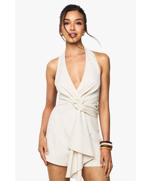 Chic halterneck design for a flattering neckline
        Stylish twist detail at the waist adds visual interest
        Linen-look fabric offers a breezy, summery feel
        Backless design for a daring, on-trend look
        Versatile playsuit suitable for various casual occasions
    
    Embrace effortless style with this captivating neckholder playsuit from Boohoo. The linen-look fabric lends a relaxed, summery vibe perfect for warm-weather outings. The halterneck design and backless cut create a striking silhouette, while the twist detail at the waist adds a touch of sophistication. Style this versatile piece with strappy sandals and a clutch for a casual brunch with friends, or dress it up with wedges and statement earrings for a garden party. The playsuit's adaptable nature makes it an ideal choice for family gatherings or impromptu weekend adventures. Layer with a lightweight cardigan for cooler evenings, or pair with trainers for a more laid-back look. This Boohoo playsuit is the ultimate addition to your casual wardrobe, offering both comfort and style for the fashion-forward woman.