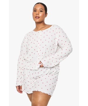 Ribbed knitted fabric for enhanced comfort and stretch
        Charming floral pattern throughout the set
        Relaxed long-sleeve top with a flattering round neckline
        Comfortable shorts with a delicate frilled hem
        Designed specifically for the plus-size figure with a generous, non-restrictive fit
    
    Drift into dreamland in style with this delightfully feminine pyjama set from Boohoo. The ribbed texture adds a tactile dimension whilst ensuring the fabric moves with you throughout the night. The sweet floral pattern brings a touch of whimsy to your nightwear collection, perfect for those who appreciate pretty details even when sleeping. Pair with fluffy slippers and a lightweight dressing gown for those midnight kitchen trips, or simply enjoy lounging about on lazy Sunday mornings with a cup of tea and your favourite book. The relaxed silhouette offers unrestricted movement, whilst the soft fabric feels gentle against the skin - essential for a restful night's sleep. This set strikes the perfect balance between comfort and charm, making it an essential addition to your nightwear drawer.