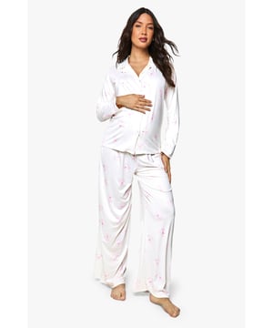 Maternity pyjama set featuring adorable bear print design
        Button-through shirt with classic collar for comfortable night-time wear
        Wide-leg trousers with relaxed fit to accommodate growing bump
        Long sleeves provide extra warmth during cooler evenings
        Soft fabric ensures maximum comfort throughout pregnancy
    
    Rest easy in this charming maternity pyjama set from Boohoo, designed specifically to keep you comfortable throughout your pregnancy journey. The classic button-through shirt with its relaxed fit allows plenty of room for your growing bump, while the wide-leg trousers offer unrestricted movement for a peaceful night's sleep. Perfect for lounging at home during those precious moments of relaxation, this set combines practicality with sweet style. The bear print adds a playful touch to your nightwear collection, making bedtime something to look forward to. Pair with cosy slippers and a warm dressing gown for those middle-of-the-night moments, or simply enjoy the soft fabric against your skin as you drift off to sleep. A thoughtful addition to any mum-to-be's wardrobe.