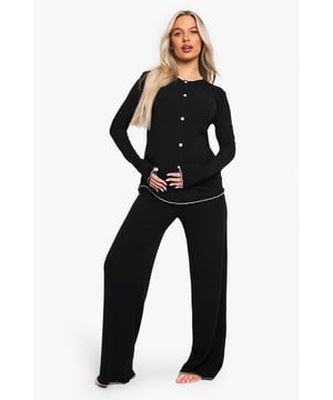 Ribbed texture for added comfort and style
        Button-down top for easy nursing access
        Contrast piping detail for a chic touch
        Wide-leg trousers for unrestricted movement
        Maternity-friendly design to accommodate growing bump
    
    Indulge in the ultimate comfort with this maternity pyjama set, perfect for mums-to-be who refuse to compromise on style. The ribbed texture adds a luxurious feel, while the button-down top offers practicality for easy nursing access. The contrast piping detail gives a sophisticated edge to your nightwear, ensuring you look put-together even during those midnight snack runs. The wide-leg trousers provide ample room for your changing body, allowing for unrestricted movement as you lounge or sleep. This set is ideal for wearing throughout your pregnancy and beyond, adapting to your body's needs. Whether you're having a relaxed night in or preparing for those early days with your newborn, this PJ set combines functionality with fashion, proving that maternity wear can be both comfortable and trendy.