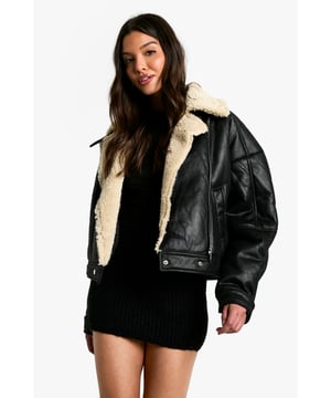 Striking contrast between dark exterior and plush Borg lining
        Oversized fit for a bold, contemporary silhouette
        Notched lapels with Borg trim for added warmth
        Practical side pockets for essentials
        Versatile cropped length suitable for various outfits
    
    Make a statement with this eye-catching Fliegerjacke, a modern twist on the classic aviator style. The contrasting Borg lining not only adds warmth but also creates a visually striking element when the jacket is open. Perfect for those chilly autumn days or cool spring evenings, this jacket effortlessly combines practicality with style. Pair it with a sleek black mini dress and chunky boots for an edgy night out look, or throw it over a casual jumper and jeans combo for weekend brunches. The oversized fit allows for easy layering, making it a versatile piece in your wardrobe. Whether you're heading to a casual family gathering or meeting friends for coffee, this Fliegerjacke will ensure you stay cosy while looking effortlessly cool. Its ability to complement both dressed-up and laid-back outfits makes it a must-have for the fashion-forward Boohoo girl who values both style and versatility.