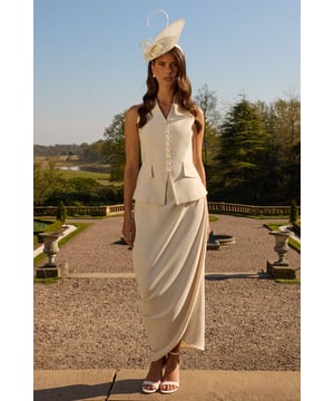 Elegant maxi skirt featuring sophisticated ruched detailing that creates a flattering silhouette
        Graceful wrap-effect design with cascading side drape for added movement and dimension
        Smooth crepe fabric with gentle stretch for comfort throughout day-to-evening wear
        Fully lined for a luxurious feel and perfect drape
        Ankle-grazing length ideal for showcasing statement footwear
    
    The Lisa Ruched Detail Maxi Skirt from Coast presents a masterclass in refined occasion dressing. The artful ruching creates gentle texture whilst the wrap-style silhouette with its cascading side detail adds a contemporary twist to this timeless piece. Style with the coordinating halterneck top as shown for a sophisticated two-piece ensemble perfect for summer weddings or race day events. For evening occasions, pair with a structured silk blouse and delicate strappy heels. The versatile design works beautifully with both minimal jewellery for understated elegance or bold statement accessories when you wish to command attention. This skirt transitions effortlessly from formal daytime events to evening celebrations, making it a valuable addition to your occasion wardrobe.