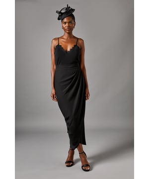 Elegant maxi skirt featuring sophisticated ruched detailing that creates a flattering silhouette
        Graceful wrap-effect design with cascading side drape for added movement and dimension
        Smooth crepe fabric with gentle stretch for comfort throughout day-to-evening wear
        Fully lined for a luxurious feel and perfect drape
        Ankle-grazing length ideal for showcasing statement footwear
    
    The Lisa Ruched Detail Maxi Skirt from Coast presents a masterclass in refined occasion dressing. The artful ruching creates gentle texture whilst the wrap-style silhouette with its cascading side detail adds a contemporary twist to this timeless piece. Style with the coordinating halterneck top as shown for a sophisticated two-piece ensemble perfect for summer weddings or race day events. For evening occasions, pair with a structured silk blouse and delicate strappy heels. The versatile design works beautifully with both minimal jewellery for understated elegance or bold statement accessories when you wish to command attention. This skirt transitions effortlessly from formal daytime events to evening celebrations, making it a valuable addition to your occasion wardrobe.