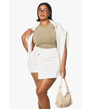 Innovative skort design combining the look of a skirt with the practicality of shorts
        Crafted from cotton denim fabric for comfort and durability
        Flattering high-waisted silhouette that enhances your curves
        Functional front button closure for a secure fit
        Versatile design perfect for casual outings and everyday wear
    
    These Plus Denim-Skorts from Boohoo offer the best of both worlds - the feminine appeal of a skirt with the comfort and confidence of shorts underneath. The high-waisted design sits perfectly at your natural waistline, creating a flattering silhouette that works brilliantly with both fitted and oversized tops. Style with a simple bodysuit as shown for daytime casual vibes, or dress up with a cropped blouse and trainers for weekend brunches. The cotton fabric provides breathability for all-day comfort, whilst the clean lines make these skorts incredibly versatile for various casual occasions. Perfect for family gatherings, shopping trips or casual meet-ups with friends - these skorts will quickly become your go-to piece when you want to look put-together without sacrificing comfort. Pair with a lightweight jacket draped over your shoulders for a stylish finishing touch.
