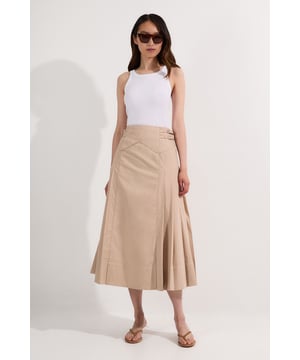 This Karen Millen woven pleated skirt combines timeless sophistication with modern detailing. The structured silhouette features precise pleating that creates beautiful movement as you walk, while the distinctive chevron-patterned waistband adds architectural interest. Style with a fitted cotton top for daytime outings, or pair with a crisp white shirt and trainers for a smart casual weekend look. The contrast stitching throughout adds subtle definition that showcases the garment's thoughtful construction. This versatile piece transitions effortlessly from office to weekend, making it an essential addition to your daywear collection.  Distinctive chevron-patterned waistband with decorative top stitching Pleated design Midi length silhouette Contrast stitching detail Secure side fastening with decorative buttons