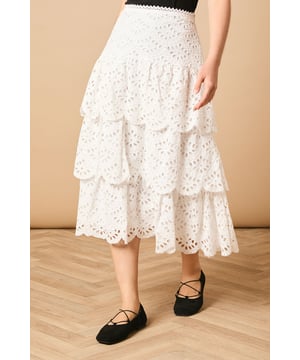 Intricate broderie anglaise detailing with floral eyelet pattern throughout
        Elegant tiered design creates beautiful movement and dimension
        Midi length falls gracefully below the knee for a feminine silhouette
        Scalloped hem adds a delicate finishing touch to each tier
        High-waisted fit accentuates the natural waistline
    
    This charming broderie tiered midi skirt from Oasis combines timeless femininity with contemporary styling. The delicate eyelet pattern creates a romantic texture that catches the light beautifully as you move, while the tiered construction adds playful volume and flow. Style with a denim waistcoat as shown for a balanced casual look, or pair with a fitted blouse for garden parties and family gatherings. The versatile midi length works wonderfully with both ankle boots for cooler days or flat sandals when the temperature rises. This skirt transitions effortlessly from daytime outings to casual evening events - simply switch your accessories to refresh your look. The high-waisted design flatters your figure whilst providing comfort for all-day wear.