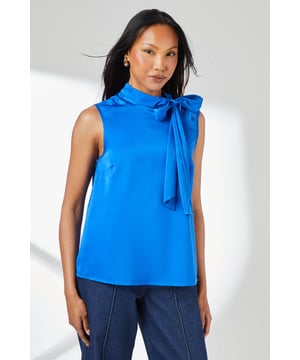 Sleeveless design with elegant high neckline for sophisticated styling
        Statement tie neck detail that can be styled as a bow or left loose for versatility
        Luxurious satin finish that catches the light beautifully
        Relaxed silhouette offering comfortable yet refined fit
        Straight-cut hemline that works perfectly tucked in or worn loose
    
    This Principles satin sleeveless top combines timeless elegance with contemporary design. The distinctive tie neck detail offers multiple styling options-create a neat bow for formal occasions or leave it draped for a more relaxed look. The sleek silhouette pairs wonderfully with tailored trousers as shown, making it ideal for important meetings or evening events. For daytime sophistication, style with a fitted blazer and court shoes, or dress it up for evening occasions with statement jewellery and a clutch bag. The versatile design transitions effortlessly from office to evening soires, while the sleeveless cut makes it perfect for layering under jackets during cooler months. This refined piece will become a cornerstone in your occasion wardrobe, offering endless styling possibilities throughout the seasons.