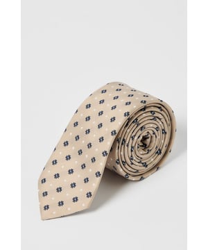 Classic foulard pattern tie with geometric motif for timeless appeal
        Standard width design suitable for both modern and traditional suit styles
        Smooth finish for comfortable all-day wear
        Neat pointed tip with branded lining detail
        Authentic Burton label for quality assurance
    
    This sophisticated foulard tie brings understated elegance to any outfit. The repeating geometric pattern creates visual interest without overwhelming your look, making it perfect for various occasions. Pair with a crisp white shirt and navy blazer for family gatherings or weekend brunches. For casual office days, match with a light blue Oxford shirt and chinos. The versatile design works brilliantly with both plain and subtly patterned shirts, allowing you to create numerous combinations from your existing wardrobe. This Burton tie offers the perfect balance between formal and relaxed styling - ideal for the man who appreciates classic accessories that transition effortlessly from day to evening events. Whether you're heading to the pub with friends or attending a casual wedding, this tie adds a refined finishing touch.