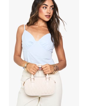 Structured grab bag featuring distinctive quilted texture with geometric pattern
        Compact yet practical size perfect for night-out essentials
        Dual top handles with gold-tone hardware accents
        Detachable shoulder strap for versatile carrying options
        Secure top zip closure with spacious main compartment
    
    This chic quilted grab bag combines style and functionality for your next night out. The structured silhouette maintains its shape while the textured quilting adds a touch of sophistication to any ensemble. Pair with a sleek bodycon dress and strappy heels for club nights, or style with tailored trousers and a silky cami top for cocktails with friends. The versatile design works equally well for day-to-evening transitions - simply adjust how you carry it from hand-held to cross-body depending on the occasion. The compact size is deceptively roomy, fitting all your going-out necessities from your mobile and cards to your favourite lipstick. A true Boohoo statement piece that completes your look without overwhelming it.
