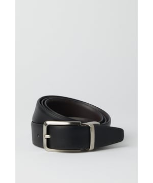 Reversible design offers two distinct looks in one versatile belt
        Sleek metal buckle with rectangular frame for a contemporary finish
        Multiple belt holes for adjustable comfort and perfect fit
        Crafted from genuine leather for durability and timeless appeal
        Clean-edge construction provides a refined, sophisticated silhouette
    
    This reversible leather belt delivers exceptional versatility for the modern gentleman. Effortlessly transition between smart and casual settings by simply flipping the belt to reveal its alternate side. The understated rectangular buckle complements both formal trousers and smart denim alike, making it an essential wardrobe staple. Style with tailored grey trousers and a crisp white shirt for important meetings, or pair with chinos and a button-down for weekend gatherings at the local. The genuine leather construction ensures this belt will age beautifully with wear, developing a unique patina over time. Perfect for the man who appreciates classic styling with practical functionality - this belt offers enduring style that works seamlessly from office to evening drinks without missing a beat.