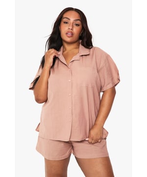 Relaxed linen-look co-ord featuring a short-sleeved shirt with classic collar and button-through front
        Comfortable shorts with elastic waistband for easy wear and perfect fit
        Practical chest pocket detail on the shirt adds a touch of casual sophistication
        Versatile two-piece set that can be worn together or styled separately
        Breathable fabric ideal for warm weather and holiday packing
    
    This effortlessly chic linen-look co-ord is your warm-weather wardrobe essential. The breezy short-sleeved shirt with its relaxed fit pairs perfectly with the comfortable elastic-waist shorts for a coordinated look that requires minimal effort. Style with trainers and a woven tote bag for casual daytime outings, or dress up with leather sandals and delicate jewellery for family gatherings and brunches with friends. The versatility of this set cannot be overstated - wear together for an instantly put-together appearance or mix with other wardrobe staples for multiple outfit options. The breathable fabric makes this an ideal choice for city breaks, beach holidays or simply lounging at home when temperatures rise. A true capsule wardrobe hero that combines comfort and style in equal measure.