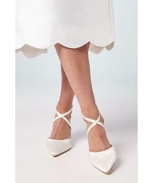 Elegant pointed toe design with cross strap detailing for sophisticated appeal
        Wide fit construction ensures all-day comfort for special occasions
        Sturdy block heel measuring between 7-9cm offers stability and height
        Secure ankle strap with adjustable buckle fastening for a customised fit
        Versatile court shoe silhouette that complements both daytime and evening attire
    
    The Treat Cross Strap Court Shoes from Coast combine timeless elegance with modern comfort. The distinctive cross strap design and pointed toe create a refined silhouette that's perfect for formal occasions. Crafted with a wide fit and featuring a stable block heel, these courts offer both style and practicality for extended wear. Pair with a flowing midi dress, as shown, for summer weddings or race day events. For evening affairs, style with tailored trousers and a silk blouse for a contemporary take on occasion dressing. The neutral hue makes these courts wonderfully versatile, allowing them to complement your entire occasion wardrobe. The adjustable ankle strap ensures a secure fit whilst adding a delicate finishing touch to this sophisticated design that will see you through countless special events with grace and poise.