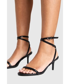 Elegant strappy design with delicate ankle wrap detail
        Low heel height between 2.5-4.5cm for comfortable all-night wear
        Minimalist open-toe silhouette for a contemporary look
        Secure ankle buckle fastening for adjustable fit
        Versatile styling potential for both casual and dressed-up occasions
    
    These essential Basic Heels from Boohoo deliver the perfect balance of style and practicality for your night-out wardrobe. The sleek, minimalist design features thin straps that gracefully frame the foot, while the ankle wrap detail adds a touch of sophistication. The low heel provides just enough height to enhance your silhouette without sacrificing comfort during long evenings out. Style these versatile heels with a figure-hugging midi dress and statement earrings for cocktails with the girls, or pair with your favourite jeans and a silky camisole for a more relaxed evening look. The understated design makes these heels an ideal foundation piece for countless outfits, ensuring they'll become a go-to choice whenever you're planning a night on the town. Their timeless appeal means they'll remain a staple in your collection season after season.