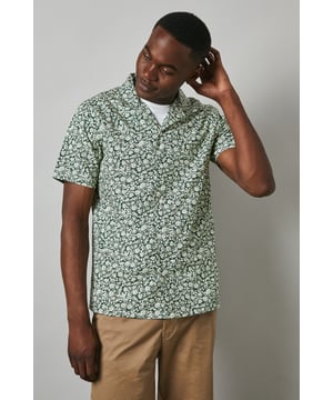 Distinctive revere collar design for a relaxed, open neckline aesthetic
        All-over floral print pattern adding visual interest and seasonal charm
        Short sleeve construction perfect for warmer weather comfort
        Cotton fabric offering breathable wear throughout the day
        Versatile regular fit that suits various body types
    
    This Maine floral print revere shirt brings a refreshing twist to casual dressing. The eye-catching pattern creates a focal point for any outfit, while the comfortable cotton construction ensures all-day wearability. Style as seen on our model with neutral chino shorts and crisp white trainers for an effortlessly cool summer look. For evening socials, pair with slim-fit trousers and loafers to transition seamlessly from day to night. The revere collar adds a touch of laid-back sophistication that works brilliantly for garden parties, weekend brunches or holiday getaways. This shirt can be worn buttoned up or open over a plain t-shirt for two distinct styling options, making it a versatile addition to your warm-weather wardrobe. Perfect for those seeking to inject personality into their casual collection.