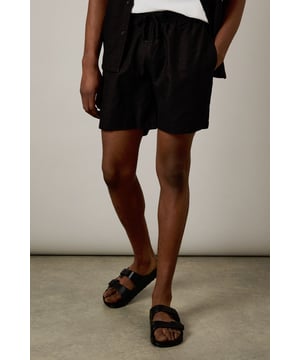 Linen blend fabric offers breathable comfort for warm-weather wear
        Classic mid-thigh length with relaxed fit for ease of movement
        Practical side pockets for everyday essentials
        Versatile design that pairs effortlessly with casual and smart-casual attire
        Clean-cut silhouette with a timeless appeal for multiple seasons
    
    These Burton linen blend shorts deliver the perfect balance of comfort and style for the modern man. The breathable fabric composition makes them ideal for warmer days, whether you're enjoying a weekend barbecue or meeting mates at your local. Style them as shown with a crisp white t-shirt for an effortless daytime look, or pair with a short-sleeve button-up shirt when the occasion calls for something a touch smarter. The versatile black hue ensures these shorts will complement your existing wardrobe with minimal effort. Perfect for casual outings, sporting events, or relaxed family gatherings, these shorts offer the laid-back sophistication Burton is known for. Their durable construction means they'll remain a staple in your summer rotation for seasons to come - simply machine wash at 30 degrees to keep them looking fresh.