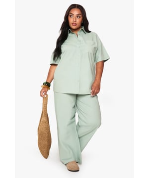 Cotton fabric provides breathable comfort for all-day wear
        Wide leg design offers a relaxed, flowing silhouette
        Elasticated waistband ensures a comfortable, adjustable fit
        Plus size tailoring designed specifically for curvier figures
        Versatile trousers that transition effortlessly from day to evening
    
    These wide leg cotton trousers from Boohoo deliver both comfort and contemporary style for the fashion-forward woman. The relaxed silhouette creates a flattering drape that moves beautifully with every step, whilst the soft cotton fabric ensures breathability throughout the day. Style them as shown with a matching button-up shirt for a coordinated set that projects confidence and sophistication. For casual outings, pair with trainers and a cropped tee, or dress them up for family gatherings with a fitted blouse and statement jewellery. The versatile design works brilliantly with both fitted and oversized tops, making these trousers a wardrobe essential that can be styled countless ways. Perfect for those seeking comfort without compromising on style.