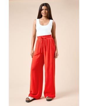 Relaxed wide-leg silhouette for effortless movement and comfort
        Elasticated paperbag waist with adjustable drawstring tie for a customisable fit
        Lightweight linen-blend fabric perfect for warmer weather
        Flowing full-length design that skims the floor when paired with flat sandals
        Versatile trousers that can be dressed up or down for various occasions
    
    These breezy linen trousers from Dorothy Perkins offer the perfect balance of comfort and style for your casual wardrobe. The relaxed wide-leg cut creates a flattering silhouette that moves beautifully with every step, while the elasticated waistband ensures all-day comfort. Style them as seen with a simple fitted vest top and flat sandals for a laid-back brunch with friends, or pair with a crisp blouse and espadrilles for family gatherings. The drawstring detail adds a touch of casual refinement, allowing you to adjust the fit to your preference. These trousers are ideal for those warm-weather occasions when you want to look polished without sacrificing comfort - perfect for garden parties, weekend shopping trips or casual Friday at the office. A versatile staple that will quickly become a go-to in your spring and summer rotation.