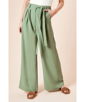 Elegant wide leg trousers featuring stylish front pleats for added dimension
        Self-tie fabric belt to define and flatter the waist
        Practical side pockets perfect for everyday essentials
        Flowing wide leg silhouette that creates a graceful drape
        Versatile woven fabric with slight stretch for all-day comfort
    
    These sophisticated pleated trousers from Dorothy Perkins combine comfort and style for the modern woman. The wide leg design creates a flattering silhouette that moves beautifully with every step, whilst the pleated front adds a touch of refinement. Style with a simple fitted t-shirt as shown for casual brunches with friends, or pair with a tucked-in blouse for family gatherings. The self-tie belt allows you to customise the fit perfectly to your waist. These trousers transition effortlessly from day to evening - simply swap your flat sandals for block heels and add statement jewellery. The practical side pockets add functionality without compromising on style. Perfect for the woman who appreciates contemporary fashion with a classic twist, these trousers will quickly become a cornerstone of your daywear collection.