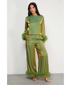 Luxurious feather trim adorning cuffs and hem
        Wide-leg silhouette for a dramatic, flowing effect
        High-waisted design for a flattering fit
        Iridescent fabric adding a subtle shimmer
        Ankle-length cut perfect for showcasing statement footwear
    
    Make a grand entrance at your next formal event with these show-stopping wide-leg trousers from Warehouse. The iridescent fabric catches the light beautifully, whilst the opulent feather trim at the cuffs and hem adds a touch of old Hollywood glamour. Style these trousers with a sleek, fitted top to balance the voluminous silhouette. For an ultra-chic ensemble, pair with metallic platform sandals and a clutch bag. These trousers are versatile enough for a range of occasions, from black-tie galas to winter weddings. The high-waisted cut elongates the legs, creating a statuesque silhouette that's sure to turn heads. Embrace your inner fashionista and let these trousers be the star of your outfit.