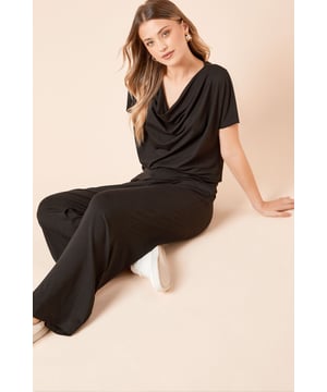 Elegant wide leg trousers with a flowing silhouette for effortless movement
        Soft woven fabric with a touch of elastane for comfortable all-day wear
        High-rise waistband that sits comfortably at the natural waist
        Versatile design that transitions seamlessly from day to evening
        Clean-lined finish with no fussy details for a timeless appeal
    
    These Dorothy Perkins wide leg trousers combine comfort and contemporary style for the modern woman. The fluid drape creates a flattering silhouette that works beautifully for various occasions, from casual brunches to family gatherings. Style them as shown with white trainers and a cowl neck top for an effortlessly chic daytime look, or dress them up with block heels and a fitted blouse for evening drinks. The elastane blend ensures these trousers maintain their shape whilst offering gentle stretch for comfort throughout the day. Their minimalist design makes them an ideal wardrobe staple that can be styled multiple ways - pair with a tucked-in t-shirt and denim jacket for weekend outings or a soft knit jumper for cooler days. Machine washable for easy care, these trousers are designed to become a go-to favourite in your collection.