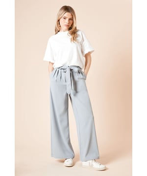 Elegant wide leg trousers featuring stylish front pleats for added dimension
        Self-tie fabric belt to define and flatter the waist
        Practical side pockets perfect for everyday essentials
        Flowing wide leg silhouette that creates a graceful drape
        Versatile woven fabric with slight stretch for all-day comfort
    
    These sophisticated pleated trousers from Dorothy Perkins combine comfort and style for the modern woman. The wide leg design creates a flattering silhouette that moves beautifully with every step, whilst the pleated front adds a touch of refinement. Style with a simple fitted t-shirt as shown for casual brunches with friends, or pair with a tucked-in blouse for family gatherings. The self-tie belt allows you to customise the fit perfectly to your waist. These trousers transition effortlessly from day to evening - simply swap your flat sandals for block heels and add statement jewellery. The practical side pockets add functionality without compromising on style. Perfect for the woman who appreciates contemporary fashion with a classic twist, these trousers will quickly become a cornerstone of your daywear collection.