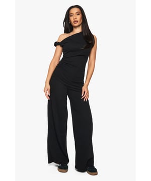 Textured knit fabric for added visual interest
        Flattering wide-leg silhouette
        High-waisted design for a lengthening effect
        One-shoulder top with ruffle detail
        Versatile matching set for effortless styling
    
    Make a statement in these eye-catching wide-leg trousers from Boohoo. The textured knit fabric adds depth and intrigue to your ensemble, while the high-waisted design elongates your silhouette. Paired with the coordinating one-shoulder top, this set offers a chic and cohesive look that's perfect for various casual occasions. Style with trainers for a laid-back daytime vibe, or dress up with wedges for an evening out. The wide-leg cut ensures comfort and movement, making these trousers ideal for family gatherings or brunches with friends. Accessorise with a sleek handbag and oversized sunglasses to complete your fashion-forward outfit. This versatile set allows for easy mixing and matching with other wardrobe staples, offering endless styling possibilities for the fashion-savvy Boohoo girl.
