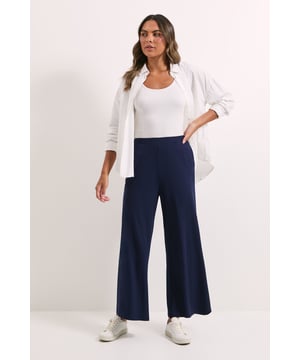 Elegant wide leg trousers with a flowing silhouette for effortless movement
        Soft woven fabric with a touch of elastane for comfortable all-day wear
        High-rise waistband that sits comfortably at the natural waist
        Versatile design that transitions seamlessly from day to evening
        Clean-lined finish with no fussy details for a timeless appeal
    
    These Dorothy Perkins wide leg trousers combine comfort and contemporary style for the modern woman. The fluid drape creates a flattering silhouette that works beautifully for various occasions, from casual brunches to family gatherings. Style them as shown with white trainers and a cowl neck top for an effortlessly chic daytime look, or dress them up with block heels and a fitted blouse for evening drinks. The elastane blend ensures these trousers maintain their shape whilst offering gentle stretch for comfort throughout the day. Their minimalist design makes them an ideal wardrobe staple that can be styled multiple ways - pair with a tucked-in t-shirt and denim jacket for weekend outings or a soft knit jumper for cooler days. Machine washable for easy care, these trousers are designed to become a go-to favourite in your collection.