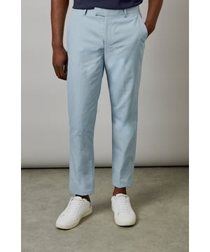 Crafted from a cotton-linen blend fabric for breathable comfort and a natural texture
        Slim fit design offers a modern, tailored silhouette that flatters the leg
        Clean front with side pockets and button-through back pockets for practicality
        Versatile light hue perfect for seasonal dressing throughout spring and summer
        Crisp centre crease adds structure and a refined finishing touch
    
    These Burton slim fit suit trousers combine classic tailoring with contemporary style. The cotton-linen blend fabric delivers a lightweight feel that's ideal for warmer weather whilst maintaining a smart appearance. Style with the matching jacket for formal occasions, or dress down with a navy crew neck and white trainers as shown for smart-casual events. The clean lines and refined cut make these trousers particularly suitable for summer weddings, garden parties, or race days. For the office, pair with a crisp shirt and loafers for a sophisticated look that transitions seamlessly from day to evening. The natural fabric blend allows for comfort during extended wear, making these trousers a practical yet stylish addition to any gentleman's wardrobe - perfect for the man who appreciates timeless style with modern sensibility.