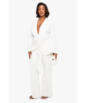 Flattering slim-fit design with dramatic flared hem for a striking silhouette
        High-waisted cut to enhance and define your natural curves
        Smooth, flowing fabric that moves beautifully with every step
        Versatile trousers that transition effortlessly from day to evening
        Plus-size design crafted specifically to celebrate fuller figures
    
    Make a bold statement in these eye-catching flared trousers from Boohoo's latest collection. The slim-fit design hugs your curves in all the right places before dramatically flaring out at the hem, creating a stunning retro-inspired silhouette that commands attention. Perfect for formal occasions, these trousers can be styled with the matching wrap top as shown for a coordinated ensemble that exudes confidence. Pair with strappy heels and statement jewellery for weddings or graduations, or dress down with a fitted blouse and block heels for dinner dates. The high waist provides excellent support and structure, whilst the flared leg elongates your silhouette beautifully. These trousers offer the perfect balance of comfort and sophistication, ensuring you'll stand out for all the right reasons at your next special event.