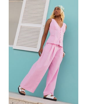 Tailored wide-leg silhouette with a dramatic flowing drape
        Elegant front pleats for added structure and dimension
        Distinctive side tie detail with decorative buttons for a feminine touch
        High-rise waistband designed to flatter the natural waistline
        Linen blend fabric offering breathability and a natural textured finish
    
    These statement trousers from Warehouse combine sophistication with contemporary flair. The wide-leg design creates a striking silhouette that moves beautifully with every step, whilst the tailored pleats add structure and refinement. Style with a simple white tee and flat sandals for effortless daytime chic, or pair with the matching waistcoat for a coordinated ensemble that's perfect for summer gatherings. The versatile design transitions seamlessly from casual brunches to family celebrations - simply swap your trainers for leather slides and add delicate jewellery to enhance the look. The linen blend fabric ensures these trousers remain comfortable throughout the day, making them an essential addition to your warm-weather wardrobe.