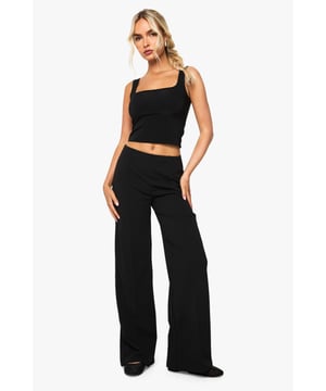 Straight leg design with elegant pintuck detailing for a refined silhouette
        High-rise waistband that sits comfortably at the natural waist
        Flattering front pintuck seams that create a lengthening effect
        Versatile straight cut that complements various body types
        Slight stretch fabric blend for all-day comfort and movement
    
    These Boohoo Straight Leg Pintuck Trousers offer the perfect balance of comfort and style for your everyday wardrobe. The classic straight leg silhouette paired with sophisticated pintuck detailing creates a polished look that works effortlessly from day to night. Style with a matching crop top and blazer for a coordinated ensemble that commands attention at family gatherings, or pair with a casual graphic tee and trainers for weekend brunches. For cooler days, layer with an oversized jumper and ankle boots for a relaxed yet put-together appearance. The versatile design makes these trousers a wardrobe essential that transitions seamlessly between casual settings and smart-casual occasions, offering endless styling possibilities while maintaining comfort throughout your day.