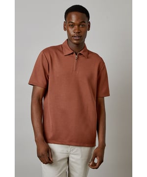 Textured fabric adds subtle dimension and visual interest to this classic polo design
        Quarter-zip neck detail offers versatile styling options and a contemporary twist
        Short sleeves with clean finish for comfortable everyday wear
        Traditional fold-down collar maintains a smart-casual appearance
        Relaxed fit through the body provides ease of movement for all-day comfort
    
    This Burton textured zip neck polo combines classic style with modern functionality, perfect for the man who appreciates timeless wardrobe staples. The quarter-zip detail allows you to adjust your look throughout the day, whether partially unzipped for a relaxed pub lunch or fully zipped for a smarter finish. Pair with light chinos as shown for summer gatherings, or layer under a bomber jacket when the temperature drops. The textured fabric adds subtle character while maintaining versatility. Ideal for weekend sporting events, casual Friday at the office, or meeting mates at your local. This polo works equally well with dark jeans and trainers for an effortless everyday look that transitions seamlessly from daytime errands to evening socialising.