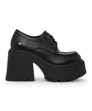 Turn heads with the Windsor Smith Starcrossed platform shoes - the ultimate fusion of attitude and height. Made with a sleek black leather upper, these chunky lace-up platforms feature the brand’s signature cleated sole, delivering both grip and standout style. The round toe and lightweight TPR construction ensure comfort, while the towering 12 cm heel and 5.3 cm platform give you maximum lift. Finished with Windsor Smith’s iconic bull symbol on the upper, they’re designed for fearless, fashion-forward looks.

Upper: Leather
Lining: Non-Leather
Sole: Lightweight TPR (cleated)
Closure: Lace-up
Toe: Round
Platform Height: 5.3 cm
Heel Height: 12 cm
Features: Chunky sole, bull logo branding