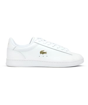 The Lacoste Carnaby Set brings classic court style to your casual collection. These elegant white leather trainers showcase subtle metallic accents that catch the light as you move. With Lacoste's signature branding tastefully placed on the tongue, heel, and quarter, these shoes offer understated luxury. The sturdy rubber cup sole provides reliable traction and durability for everyday wear. Perfect for pairing with anything from tailored trousers to summer dresses.