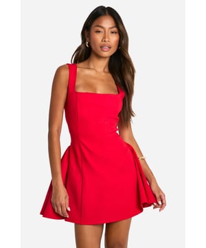 Striking square neckline for a modern twist
        Sleeveless design with wide straps for a flattering silhouette
        Figure-hugging bodice that flares into a playful skirt
        Mini length perfect for showcasing legs
        Versatile style suitable for various evening occasions
    
    Make a bold statement with this eye-catching mini dress that's designed to turn heads. The square neckline adds a contemporary edge, while the sleeveless cut and wide straps create a balanced and flattering upper body shape. The dress's silhouette is expertly crafted to hug your curves before gracefully flaring out into a flirty skirt, offering both comfort and style. Perfect for a night out on the town, this dress pairs beautifully with strappy heels and statement earrings for a look that's sure to impress. Whether you're dancing the night away at a club or enjoying cocktails at a trendy bar, this versatile piece will keep you looking chic and feeling confident. For a more relaxed vibe, throw on a leather jacket and ankle boots to effortlessly transition from day to night.