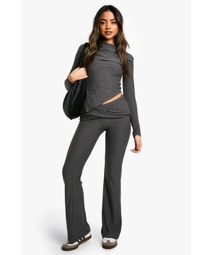Flared leg design for a retro-inspired silhouette
        Unique twist-waist detail adds interest and flatters the midsection
        Super-soft fabric ensures all-day comfort
        High-rise fit elongates the legs
        Versatile style suitable for both casual and dressy occasions
    
    Make a statement with these eye-catching flared trousers from Boohoo. The standout twist-waist detail adds a contemporary edge to the classic silhouette, creating a flattering look that's perfect for a night out. Pair with a cropped top to showcase the unique waistline, or tuck in a fitted blouse for a more polished ensemble. The super-soft fabric ensures comfort whether you're dancing the night away or enjoying drinks with friends. Dress them up with heeled sandals and statement jewellery for a club-ready look, or keep it casual with trainers and a denim jacket for daytime outings. These versatile trousers are a must-have addition to any fashion-forward wardrobe, offering endless styling possibilities for the trendsetting Boohoo girl.