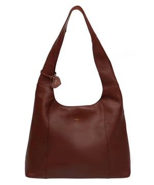 The 'Renata' shoulder bag from NiNa Amora elevates this design with the natural leather exeterior with a soft to the touch pebble grain finish. A open-top design gives it a relaxed slouchy look and conceals the spacious main compartment. This is comnplemented by a zipped pocket on the lined interior for a robust finish. A chunky single handle adorns this style and makes it comfortable to wear all day long. This is all finished with the NiNa Amora X logo embossed in stunning silver foil on the front and hanging charm for a luxurious finishing touch.