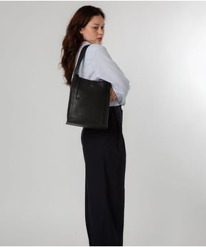 Handcrafted from high quality natural leather, the 'Catarina' tote bag takes the classic design elevates it with unique design choices. This style from the NiNa Amora range features a mix of magnetic press stud and a zipped compartment sections, providing ample space for all your essentials. Addition storage is provided by a slip and zipped pocket which line the interior. Dual slim handles adorn the bag with a drop length of 24cm. Silver metal fittings  give this design a elegant look which complement the NiNa Amora X logo which is embossed in silver foil on the front and hanging charm for a luxurious finishing touch.