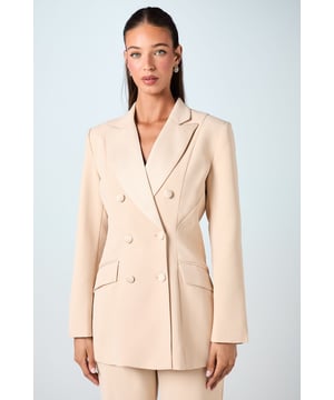 Double-breasted design with elegant button detailing
        Hourglass silhouette for a flattering, feminine fit
        Structured shoulders and long sleeves for a polished look
        Crafted from smooth crepe fabric for a luxurious feel
        Versatile piece suitable for both formal and semi-formal occasions
    
    Exquisitely tailored to accentuate your curves, this Coast blazer is the epitome of sophisticated elegance. The double-breasted design and hourglass silhouette work in harmony to create a striking, feminine profile that's perfect for special occasions. Whether you're attending a wedding or heading to the races, this blazer will ensure you look effortlessly chic. Style it with the matching trousers for a coordinated suit ensemble, or pair it with a sleek pencil skirt for a more versatile look. The smooth crepe fabric drapes beautifully, allowing for comfortable movement throughout your event. Accessorise with delicate jewellery and a clutch bag to complete your refined outfit. This blazer is a true investment piece that will serve you well for numerous formal gatherings and celebrations.