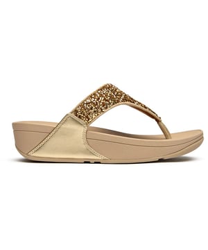 The Fitflop Lulu Shimmerfoil brings glamour to your everyday stride with its eye-catching metallic finish that catches the light beautifully. These sophisticated flip flops feature Fitflop's signature micro wobbleboard sole technology, delivering exceptional comfort and support with every step. The 4cm heel adds a subtle lift while the shimmering synthetic upper creates an effortlessly chic look that transitions seamlessly from poolside to pavement.