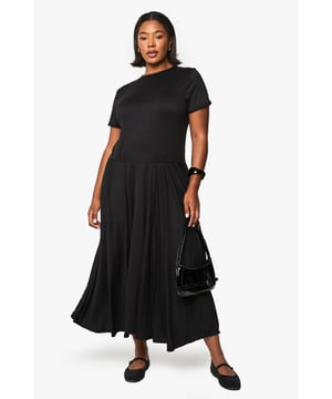 Relaxed T-shirt style bodice with classic crew neckline for everyday comfort
        Flowing maxi-length skirt with generous volume for graceful movement
        Short sleeves with neat finish for a clean, contemporary silhouette
        Soft viscose fabric drapes beautifully around the figure
        Versatile drop-waist design creates an effortlessly chic look
    
    This T-shirt-style maxi dress combines comfort with understated sophistication. The relaxed bodice transitions into a voluminous skirt that creates a flattering silhouette for all body types. Style with flat ballet pumps and a structured handbag as shown for daytime outings, or transform your look with chunky trainers and a denim jacket for casual weekend brunches. For evening gatherings, add statement jewellery and a leather jacket for an edgy contrast to the dress's flowing lines. The simple design makes this piece perfect for layering during cooler months - try with a longline cardigan and ankle boots. This wardrobe essential works beautifully for family gatherings, casual office days, or weekend city breaks where versatility is key.