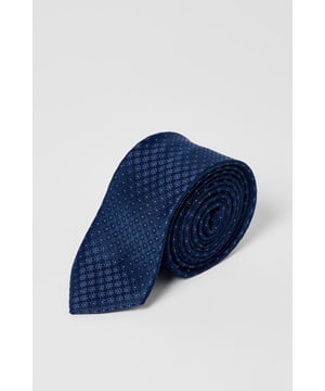 Classic foulard pattern tie featuring a subtle geometric design
        Standard width suitable for both modern and traditional suit styles
        Branded Burton label for authentic detailing
        Machine washable for easy care and maintenance
        Versatile one-size design that works with any collar style
    
    This Burton foulard tie brings understated sophistication to your wardrobe essentials. The timeless geometric pattern works brilliantly with both plain and subtly patterned shirts, making it a versatile choice for various occasions. Pair with a crisp white shirt and navy blazer for family gatherings, or team with a light blue Oxford shirt and chinos for casual Friday at the office. The tie's classic styling makes it equally appropriate for a day at the races or an evening at your local for a more refined pub look. The washable fabric means you can keep it looking fresh without trips to the dry cleaner. A wardrobe staple that bridges the gap between smart and casual, this tie offers the reliability and classic style that Burton customers appreciate.