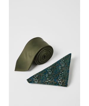 Classic khaki tie with a sleek, streamlined silhouette
        Complementary ditsy floral pocket square with intricate pattern detail
        Versatile one-size design suitable for all formal and smart-casual occasions
        Subtle textured finish on the tie adds depth and visual interest
        Coordinated set that eliminates the guesswork of accessorising
    
    This Burton tie and pocket square set offers the perfect finishing touch to your formal and smart-casual ensembles. The khaki tie provides a contemporary alternative to traditional darker shades, while the patterned pocket square introduces a touch of personality with its ditsy floral design. Pair with a navy or grey suit for traditional occasions, or use to sharpen up a simple shirt and trousers combination for more relaxed gatherings. The set works brilliantly for family celebrations, casual workplace environments, or weekend pub lunches with mates. For a refined look, fold the pocket square into a neat triangle or square puff, allowing just a hint of pattern to show. This accessible accessory set delivers that considered, put-together appearance without requiring extensive styling knowledge - ideal for the man who appreciates straightforward yet impactful style.