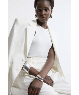Throw it back to the '90s and polish off an occasion look with a bangle stack, featuring a curved design, and shining metallic material. Wear it on wedding guest days, party nights, and date days to add a little extra detail to any look. Curved Bangle Stack Bold, Chunky Design Shimmering Metallic Material Statement Curved Design Slip On DesignBrowse this seasons women's jewellery or discover the full range of women's accessories now.