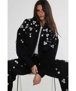 Stunning floral appliqu embellishments
        Oversized, relaxed fit for effortless style
        Front patch pockets for practicality
        Elasticated hem for a snug fit
        Versatile zip-up front closure
    
    Make a bold statement with this eye-catching embellished denim jacket from NastyGal. The scattered floral appliqus create a whimsical, feminine touch that contrasts beautifully with the rugged denim fabric. Perfect for those nights out when you want to turn heads, this jacket can be styled in numerous ways. Pair it with wide-leg jeans and a crop top for a trendy double denim look, or throw it over a slinky dress to add an edgy twist to your evening ensemble. The oversized fit allows for layering, making it ideal for transitional weather. Whether you're heading to a club, meeting friends at a bar, or exploring the urban nightlife, this unique piece will ensure you stand out from the crowd while keeping you comfortably stylish all night long.