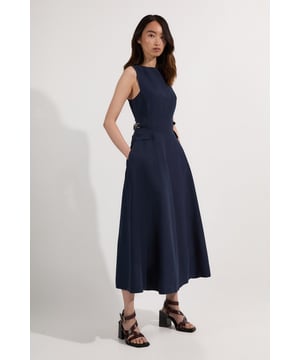 Experience everyday elegance in our midi dress, made with summer ready linen fabric, with a fit and flare silhouette and tab details designed to cinch the waist. Style it with sandals or court heels for a look that will take you from summer office days to date nights. Premium Linen Tab Waist Detail Full Skirt Tailored Midi Dress High Quality Linen Fabric Flattering Fitted Bodice Dramatic Flared Skirt Unique Tab Accents on Waist Pocket Detailing Sleeveless Design Zip Fastening in Back