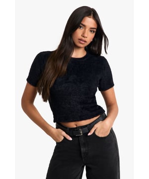Fluffy knit texture for a cosy feel
        Cropped length for a trendy silhouette
        Short sleeves for versatile wear
        Crew neckline for a classic touch
        Fitted design to accentuate your figure
    
    Embrace casual chic with this fluffy knit baby T-shirt from Boohoo. Perfect for the fashion-forward woman who values both style and comfort, this versatile piece can effortlessly transition from day to night. Pair it with high-waisted jeans and trainers for a laid-back brunch with friends, or dress it up with a sleek blazer and wide-leg trousers for an evening out. The cropped length adds a playful edge, while the soft texture invites tactile appreciation. Ideal for family gatherings or casual outings, this top radiates youthful energy and contemporary flair. Layer it under a denim jacket for cooler days or wear it solo when the temperature rises. With its ability to complement various looks, this fluffy knit T-shirt is set to become a staple in your wardrobe, offering endless styling possibilities for the modern British fashionista.