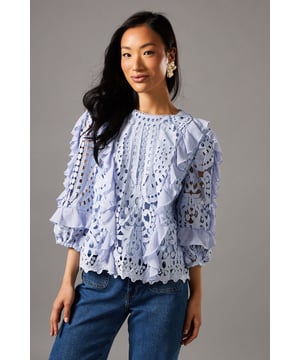 Intricate lace pattern with floral motifs
        Voluminous frill sleeves for a romantic touch
        Round neckline with delicate scalloped edges
        Keyhole back closure for an elegant finish
        Versatile design suitable for various formal occasions
    
    Embrace sophistication with this exquisite lace frill sleeve top from Coast. The intricate lace pattern, adorned with delicate floral motifs, creates a luxurious and feminine aesthetic. The voluminous frill sleeves add a touch of romance and drama, perfect for those seeking a statement piece. Pair this top with the matching lace shorts for a coordinated ensemble that exudes elegance and refinement. Ideal for weddings, race days, or sophisticated garden parties, this versatile piece can be styled to suit a range of formal events. Complete your look with strappy metallic heels and statement earrings to enhance the top's ornate design. For a more understated approach, team it with tailored trousers and classic court shoes. This Coast top is a testament to timeless style, ensuring you'll stand out at any occasion with grace and poise.
